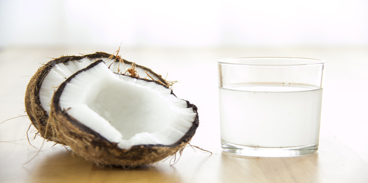 A glass of water from mature coconut